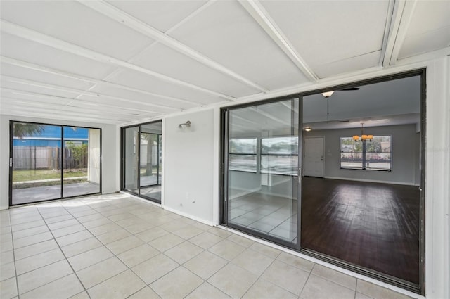 interior space with baseboards and a notable chandelier