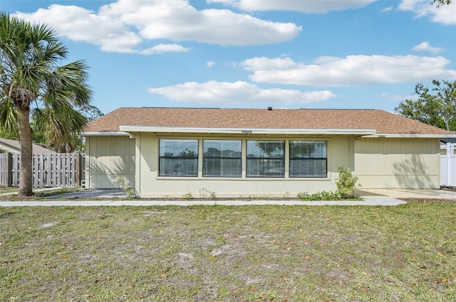 view of front of property with a front yard and fence