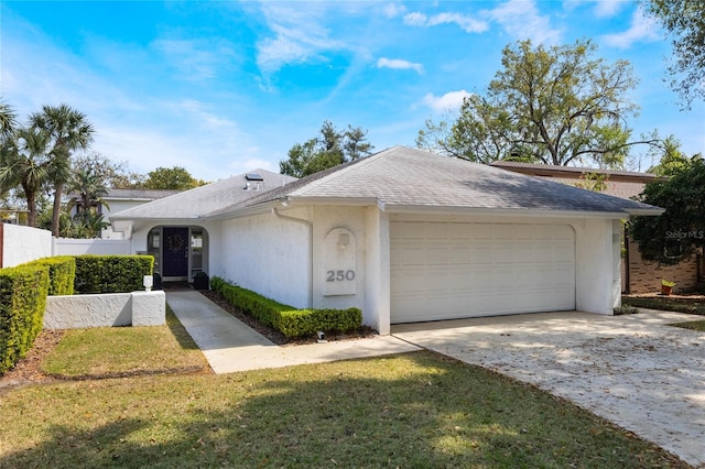 ranch-style house featuring stucco siding, fence, concrete driveway, a shingled roof, and a garage