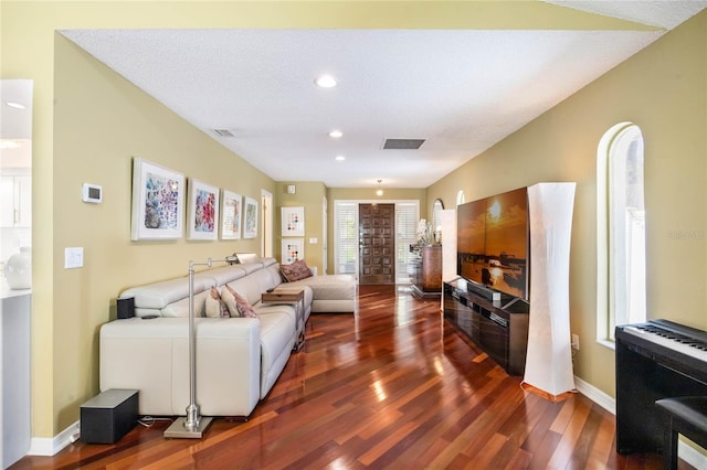 living room featuring recessed lighting, wood finished floors, visible vents, and baseboards