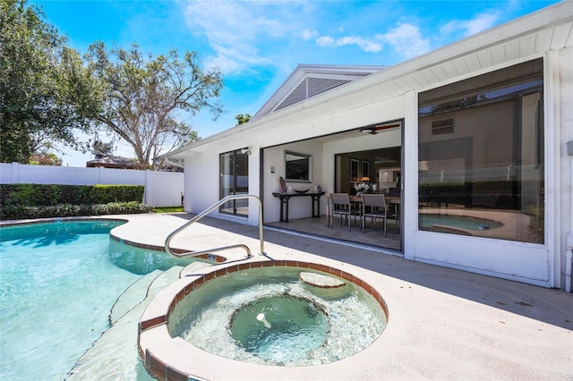 view of swimming pool with a patio area, a fenced in pool, an in ground hot tub, and fence