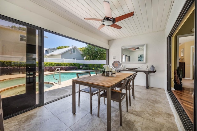 sunroom featuring wood ceiling and ceiling fan