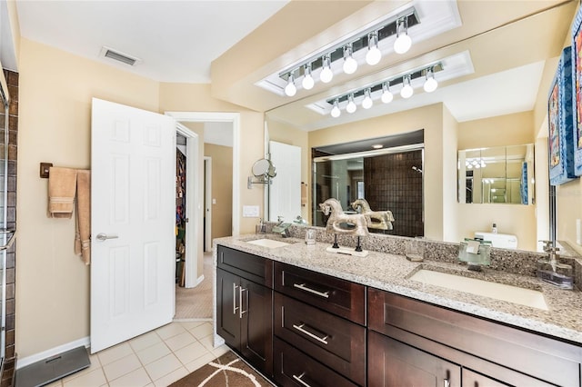 bathroom featuring a shower stall, visible vents, tile patterned floors, and a sink