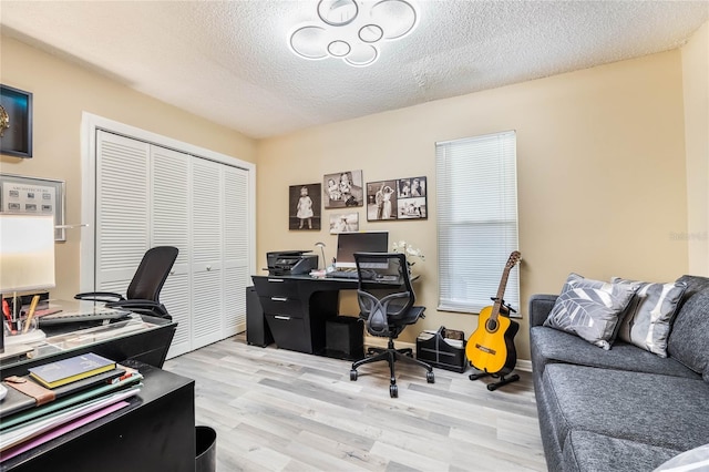 office featuring light wood-style floors and a textured ceiling