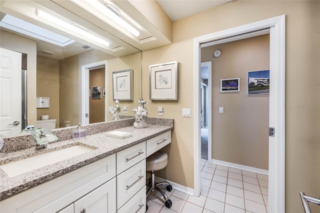 bathroom with vanity, visible vents, baseboards, tile patterned floors, and toilet