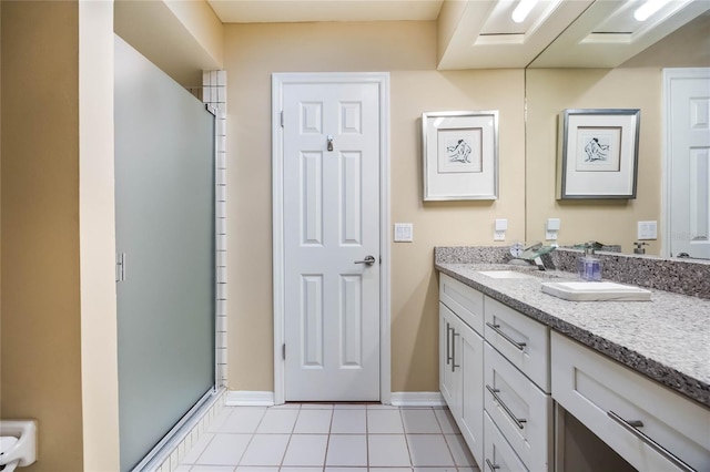 bathroom with tile patterned flooring, a stall shower, vanity, and baseboards