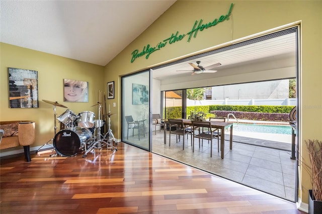 dining space featuring baseboards, a ceiling fan, lofted ceiling, and wood finished floors