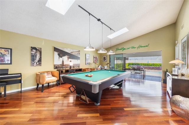 recreation room with vaulted ceiling with skylight, a textured ceiling, billiards, and wood finished floors