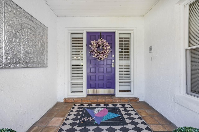 doorway to property with stucco siding