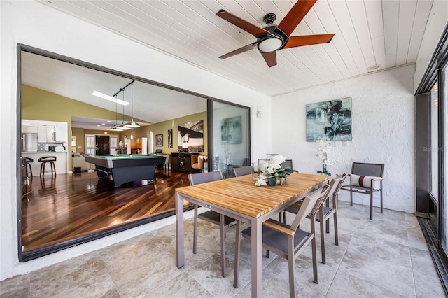 dining space with a ceiling fan, billiards, wooden ceiling, vaulted ceiling, and a textured wall