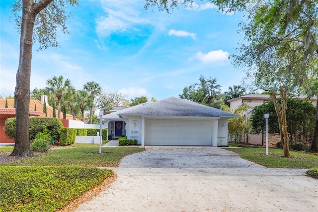 single story home with stucco siding, driveway, a front lawn, and an attached garage