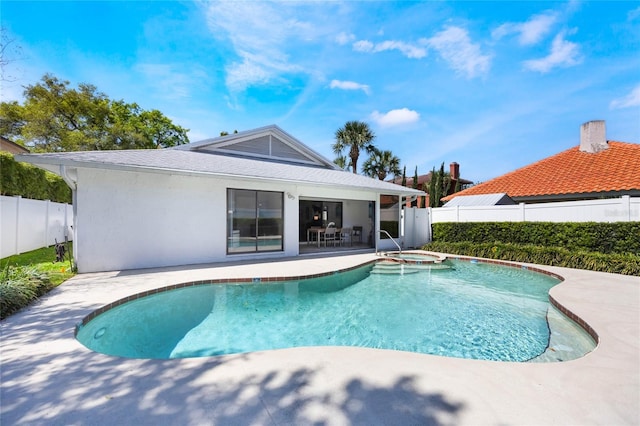 view of pool with a patio area, a fenced backyard, and a pool with connected hot tub