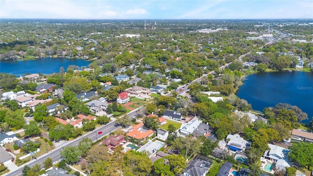 drone / aerial view featuring a residential view and a water view