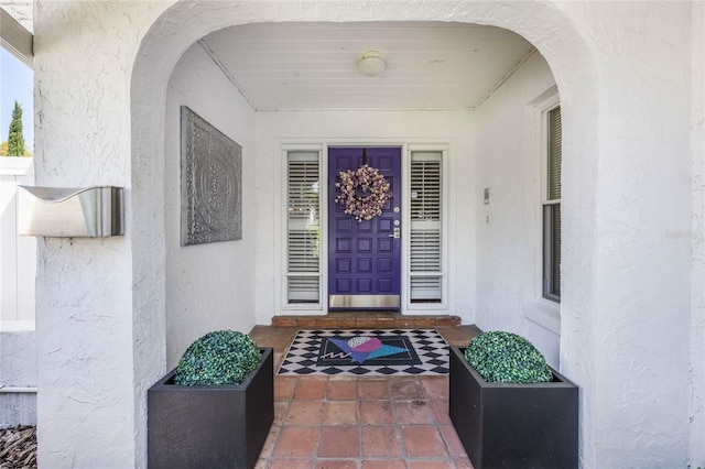 property entrance with stucco siding