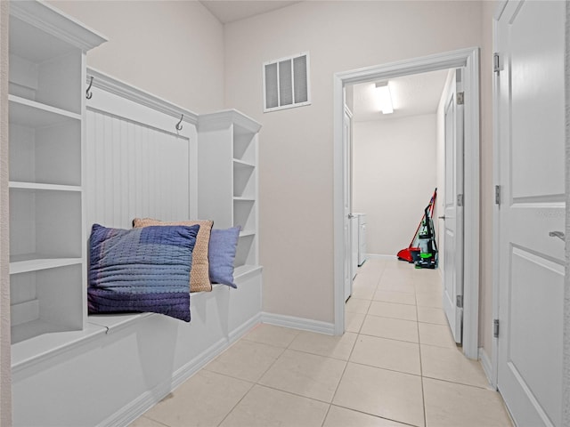 interior space featuring tile patterned flooring, baseboards, and visible vents