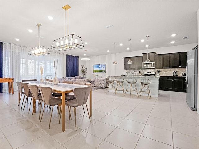 dining space with light tile patterned flooring, a chandelier, recessed lighting, and visible vents