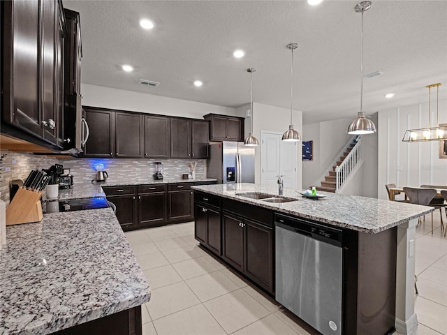 kitchen featuring a sink, stainless steel appliances, visible vents, and decorative backsplash