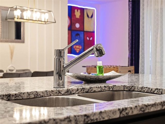 room details featuring a sink and stone counters