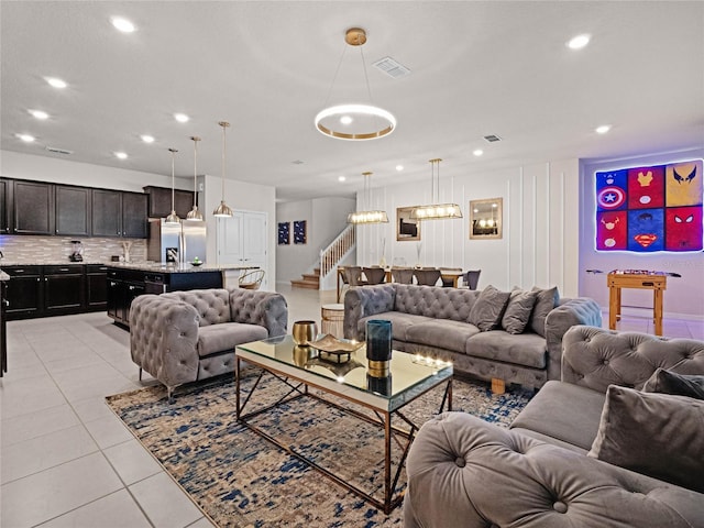 living area featuring recessed lighting, stairway, visible vents, and light tile patterned flooring