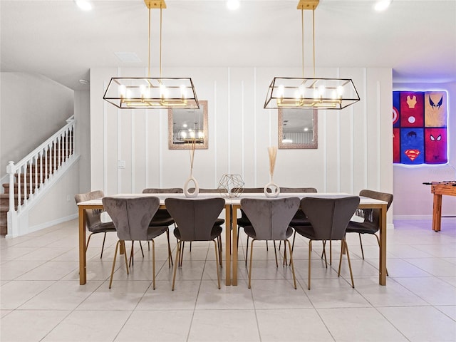 dining room featuring an inviting chandelier, stairway, and light tile patterned floors