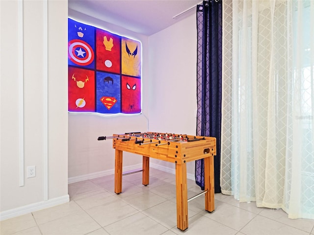 rec room with tile patterned floors and baseboards