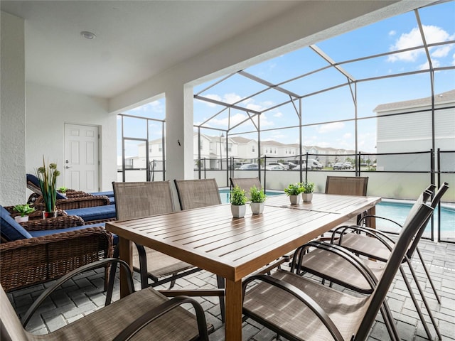 view of patio with a lanai, an outdoor pool, and outdoor dining area