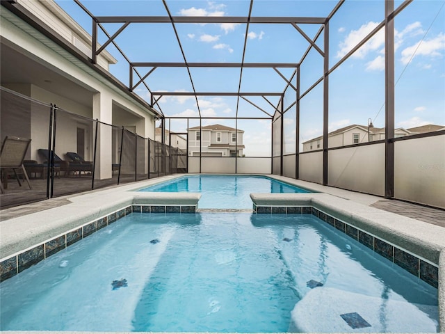 view of pool with a pool with connected hot tub, a lanai, and a patio area