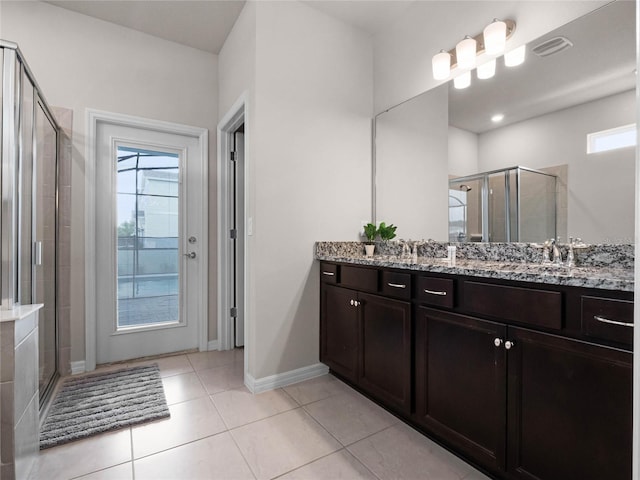 bathroom with a wealth of natural light, visible vents, a stall shower, and vanity