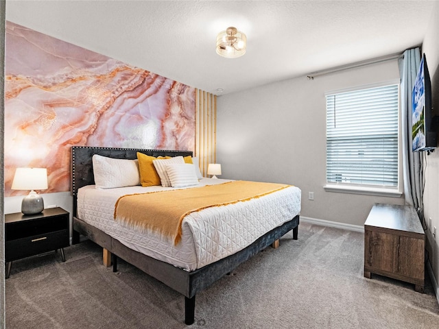 carpeted bedroom featuring baseboards and a textured ceiling