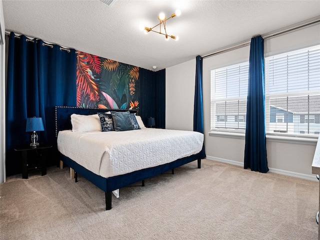 carpeted bedroom with a textured ceiling and baseboards