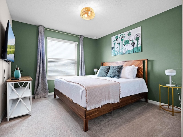 carpeted bedroom featuring baseboards and a textured ceiling