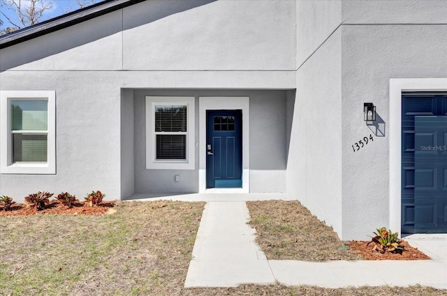 entrance to property with stucco siding