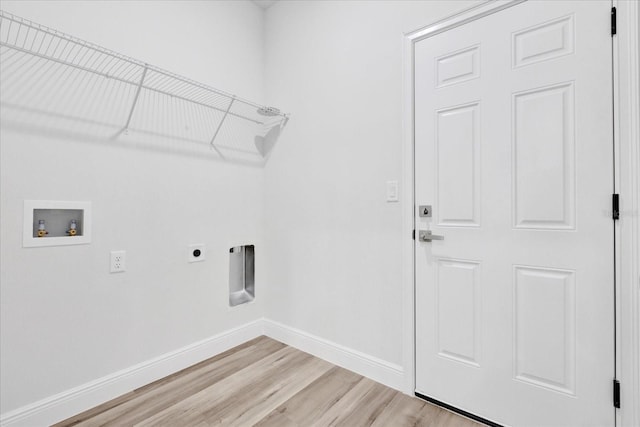 clothes washing area featuring light wood-style floors, baseboards, hookup for an electric dryer, hookup for a washing machine, and laundry area