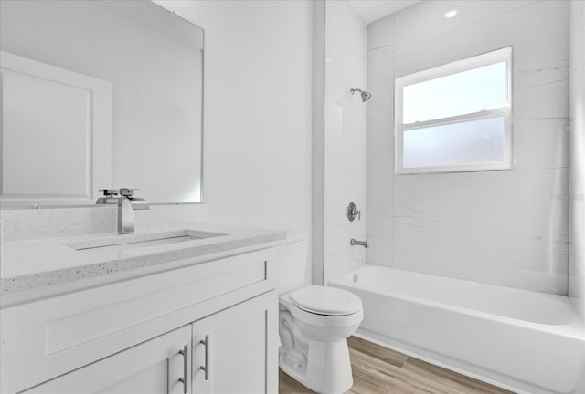 full bath featuring toilet, vanity, shower / bathing tub combination, and wood finished floors