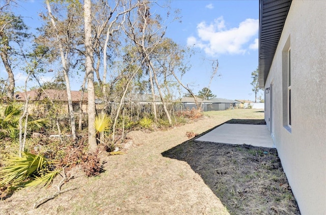 view of yard featuring a patio and fence