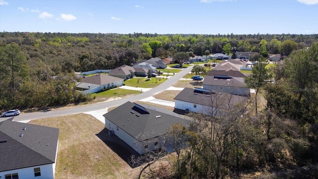 drone / aerial view with a forest view and a residential view