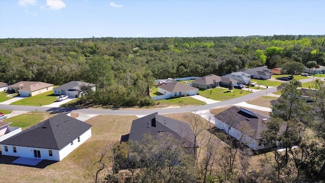 birds eye view of property featuring a residential view and a view of trees