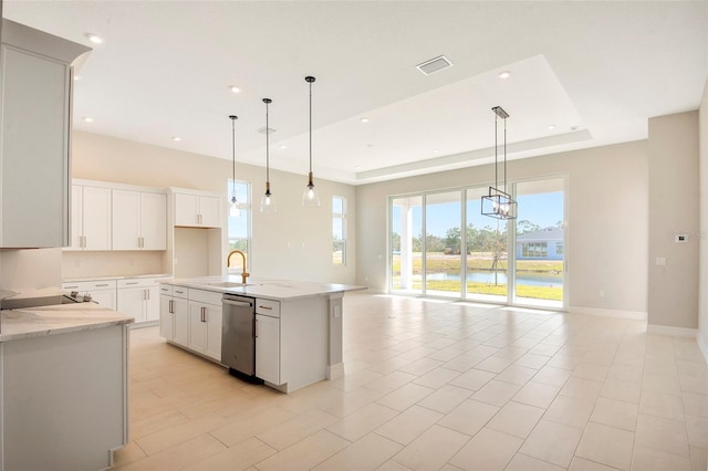 kitchen with visible vents, a sink, a tray ceiling, open floor plan, and dishwasher