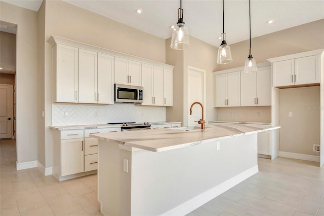 kitchen featuring a sink, white cabinets, an island with sink, and stainless steel appliances