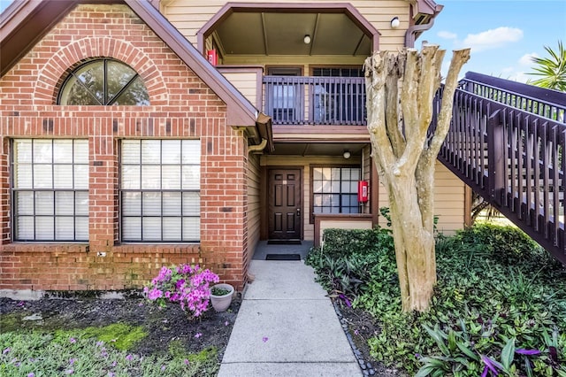 doorway to property featuring brick siding