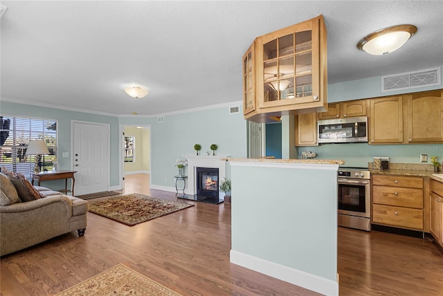 kitchen with visible vents, open floor plan, dark wood finished floors, appliances with stainless steel finishes, and glass insert cabinets