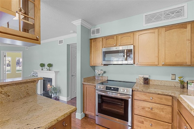 kitchen featuring visible vents, appliances with stainless steel finishes, and a textured ceiling