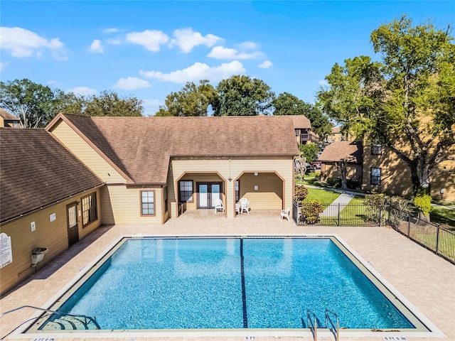 pool featuring a patio, french doors, and fence