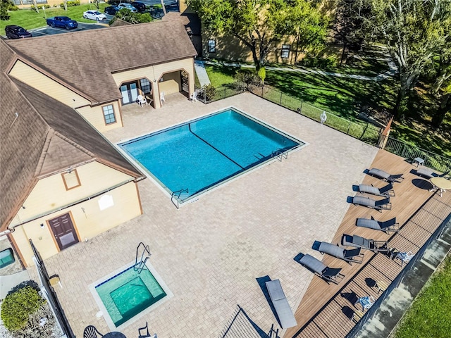 community pool featuring a patio area and fence