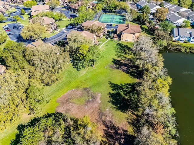 drone / aerial view featuring a residential view and a water view