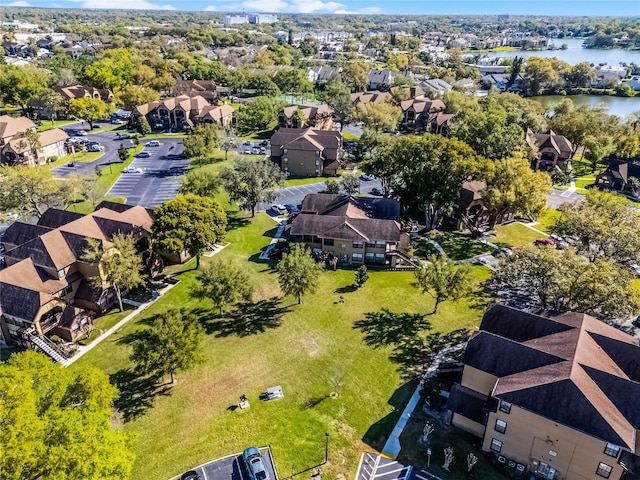 drone / aerial view with a residential view and a water view