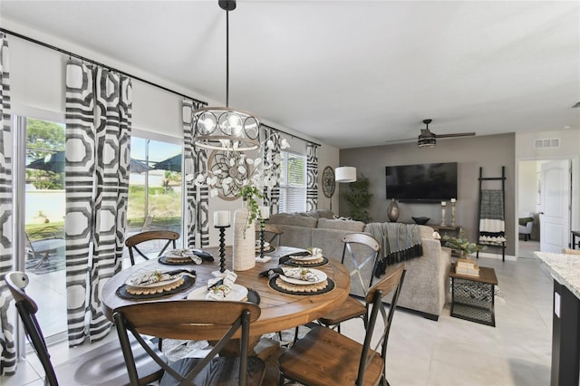 dining space featuring light tile patterned floors, a ceiling fan, and visible vents