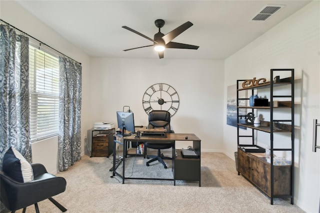 carpeted home office featuring visible vents, baseboards, and a ceiling fan