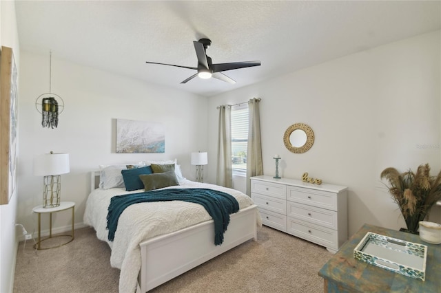 bedroom with light carpet and ceiling fan