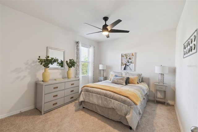 bedroom featuring baseboards, light carpet, and ceiling fan